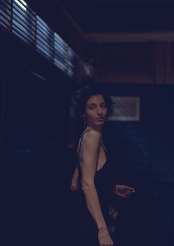 A lone woman at a bar, moody and cinematic